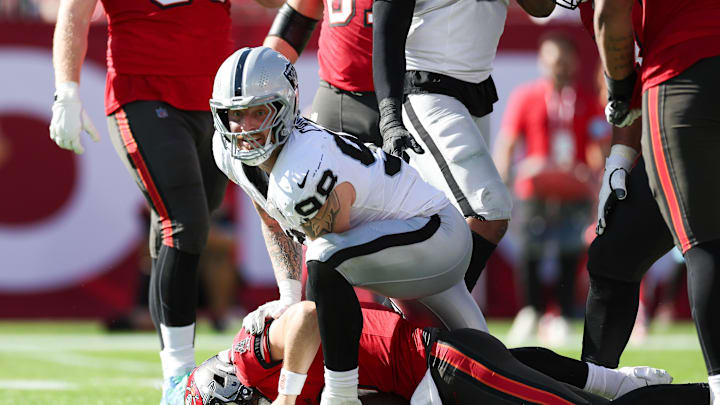 Dec 8, 2024; Tampa, Florida, USA; Las Vegas Raiders defensive end Maxx Crosby (98) sacks Tampa Bay Buccaneers quarterback Baker Mayfield (6) in the second quarter at Raymond James Stadium. Mandatory Credit: Nathan Ray Seebeck-Imagn Images