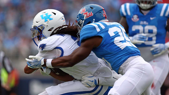 Sep 28, 2024; Oxford, Mississippi, USA; Kentucky Wildcats quarterback Gavin Wimsatt (2) runs the ball as Mississippi Rebels defensive back Trey Washington (25) makes the tackle during the first half at Vaught-Hemingway Stadium. Mandatory Credit: Petre Thomas-Imagn Images
