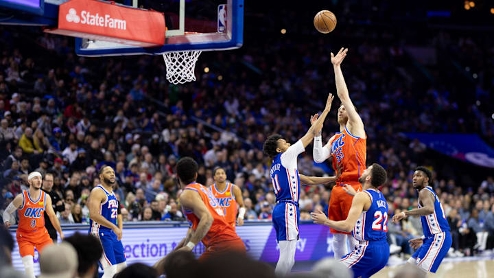 Jan 14, 2025; Philadelphia, Pennsylvania, USA; Oklahoma City Thunder center Isaiah Hartenstein (55) shoots past Philadelphia 76ers guard Jeff Dowtin Jr. (11) during the second quarter at Wells Fargo Center. Mandatory Credit: Bill Streicher-Imagn Images