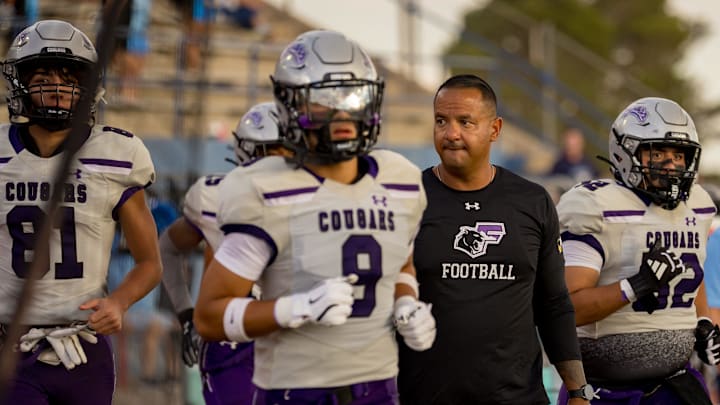 Franklin players and head football coach Ruben Torres take the field for the Cougars’ season opener against Chapin on Thursday, Aug. 28, 2025, at Irvin High School in El Paso, Texas.