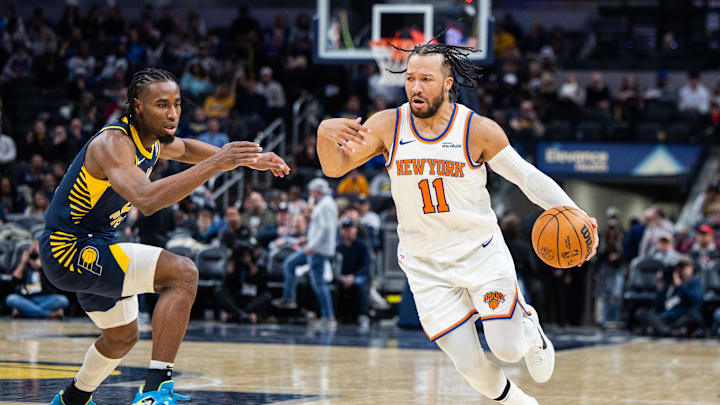 Feb 11, 2025; Indianapolis, Indiana, USA; New York Knicks guard Jalen Brunson (11) dribbles the ball while Indiana Pacers forward Aaron Nesmith (23) defends in the second half at Gainbridge Fieldhouse. Mandatory Credit: Trevor Ruszkowski-Imagn Images