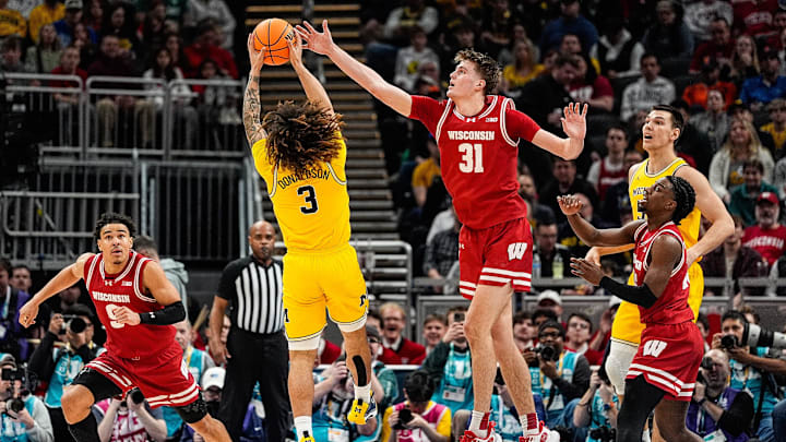 Michigan guard Tre Donaldson (3) grabs a rebound against Wisconsin forward Nolan Winter (31) during the first half of Big Ten Tournament championship game at Gainbridge Fieldhouse in Indianapolis, Ind. on Sunday, March 16, 2025.