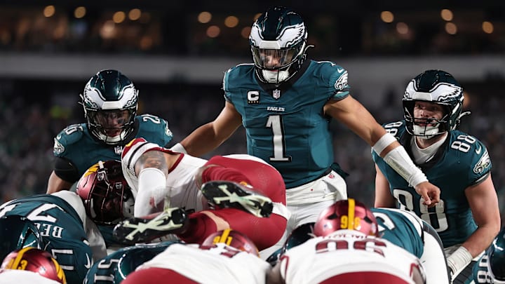 Jan 26, 2025; Philadelphia, PA, USA; Philadelphia Eagles quarterback Jalen Hurts (1) reacts as Washington Commanders linebacker Frankie Luvu (4) leaps over linemen before a snap during the second half in the NFC Championship game at Lincoln Financial Field. Mandatory Credit: Bill Streicher-Imagn Images