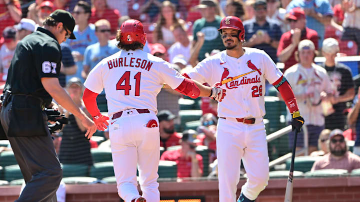 Sep 17, 2025; St. Louis, Missouri, USA; St. Louis Cardinals first baseman Alec Burleson (41) is congratulated at home plate by St. Louis Cardinals third baseman Nolan Arenado (28) after he hit a home run against the Cincinnati Reds in the first inning at Busch Stadium. Mandatory Credit: Tim Vizer-Imagn Images