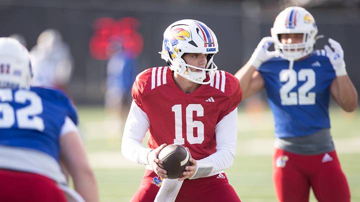 Kansas freshman quarterback David McComb (16) works through drills during an outdoor practice on Thursday, March 27, 2025. Kansas freshman quarterback David McComb (16) works through drills during an outdoor practice on Thursday, March 27, 2025.