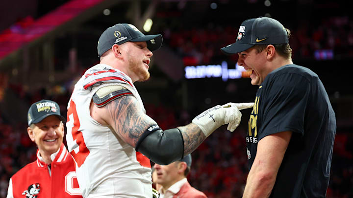 Jan 20, 2025; Atlanta, GA, USA; Ohio State Buckeyes defensive end Jack Sawyer (33) and quarterback Will Howard (18) celebrate after winning the CFP National Championship college football game at Mercedes-Benz Stadium. Mandatory Credit: Mark J. Rebilas-Imagn Images