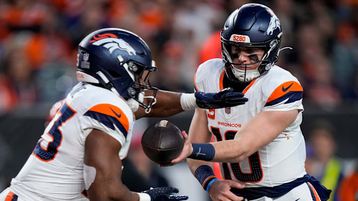 Denver Broncos quarterback Bo Nix (10) hands off to running back Audric Estime (23) in the second quarter of the NFL Week 17 game between the Cincinnati Bengals and the Denver Broncos at Paycor Stadium in downtown Cincinnati on Saturday, Dec. 28, 2024. Denver Broncos quarterback Bo Nix (10) hands off to running back Audric Estime (23) in the second quarter of the NFL Week 17 game between the Cincinnati Bengals and the Denver Broncos at Paycor Stadium in downtown Cincinnati on Saturday, Dec. 28, 2024.