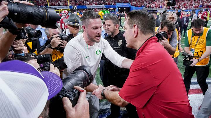 Indiana Hoosiers head coach Curt Cignetti shakes hands with Oregon Ducks head coach Dan Lanning on Friday, Jan. 9, 2026, after the Indiana Hoosiers defeated the Oregon Ducks in the Peach Bowl and semifinal game of the College Football Playoff at Mercedes-Benz Stadium in Atlanta. Indiana Hoosiers head coach Curt Cignetti shakes hands with Oregon Ducks head coach Dan Lanning on Friday, Jan. 9, 2026, after the Indiana Hoosiers defeated the Oregon Ducks in the Peach Bowl and semifinal game of the College Football Playoff at Mercedes-Benz Stadium in Atlanta.