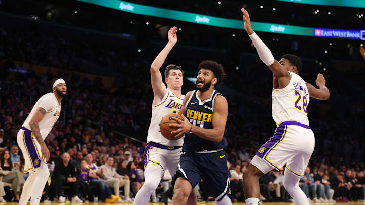 Nov 23, 2024; Los Angeles, California, USA; Denver Nuggets guard Jamal Murray (27) drives to the basket between Los Angeles Lakers guard Austin Reaves (15) and forward Rui Hachimura (28) during the second quarter at Crypto.com Arena. Mandatory Credit: Kiyoshi Mio-Imagn Images Nov 23, 2024; Los Angeles, California, USA; Denver Nuggets guard Jamal Murray (27) drives to the basket between Los Angeles Lakers guard Austin Reaves (15) and forward Rui Hachimura (28) during the second quarter at Crypto.com Arena. Mandatory Credit: Kiyoshi Mio-Imagn Images