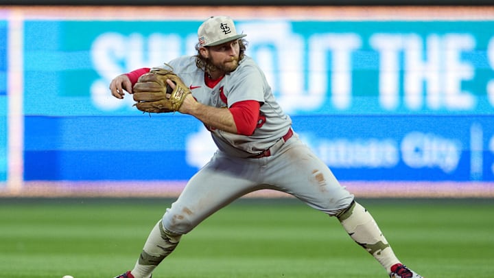 May 16, 2025; Kansas City, Missouri, USA; St. Louis Cardinals second baseman Brendan Donovan (33) drops the ball while attempting to throw to first base during the fifth inning against the Kansas City Royals at Kauffman Stadium. Mandatory Credit: Jay Biggerstaff-Imagn Images