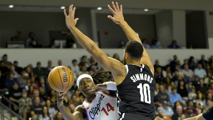 Oct 8, 2024; Oceanside, California, USA; Los Angeles Clippers guard Terance Mann (14) passes the ball around Brooklyn Nets guard Ben Simmons (10) in the first half at Frontwave Arena. Mandatory Credit: Jayne Kamin-Oncea-Imagn Images