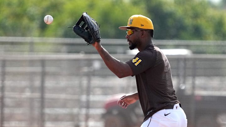 Feb 15, 2026; Peoria, AZ, USA; San Diego Padres first baseman Miguel Andujar (41) takes fielding practice during spring training camp. Mandatory Credit: Rick Scuteri-Imagn Images