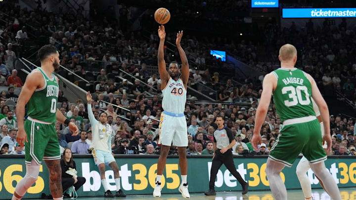 Mar 29, 2025; San Antonio, Texas, USA;  San Antonio Spurs forward Harrison Barnes (40) shoots in front of Boston Celtics forwards Jayson Tatum (0) and Sam Hauser (30) in the first half at Frost Bank Center. Mandatory Credit: Daniel Dunn-Imagn Images