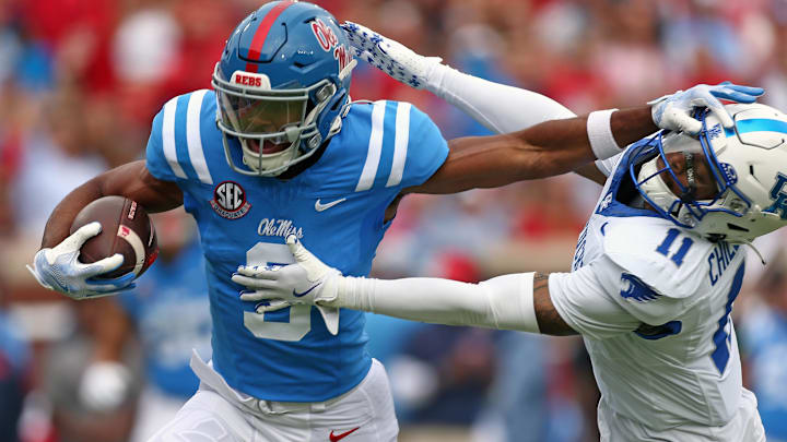 Mississippi Rebels wide receiver Tre Harris (9) stiff arms Kentucky Wildcats defensive back Zion Childress (11).