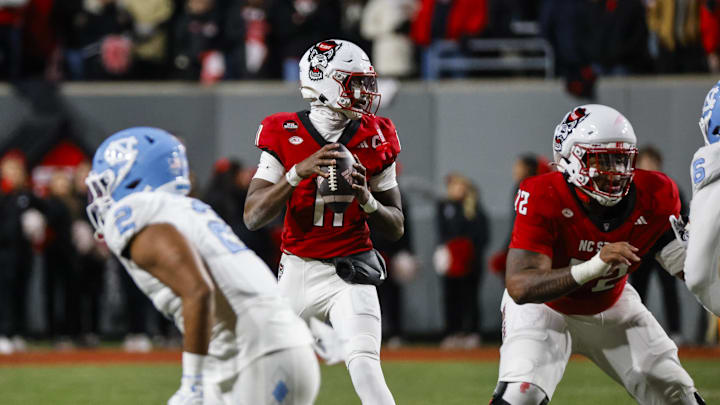 Nov 29, 2025; Raleigh, North Carolina, USA; NC State Wolfpack quarterback CJ Bailey (11) with the ball during the first half of the game against North Carolina Tar Heels at Carter-Finley Stadium.  Mandatory Credit: Jaylynn Nash-Imagn Images