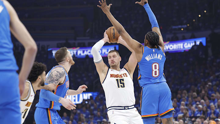 May 18, 2025; Oklahoma City, Oklahoma, USA; Denver Nuggets center Nikola Jokic (15) is defended by Oklahoma City Thunder center Isaiah Hartenstein (55) and guard Shai Gilgeous-Alexander (2) as he passes the ball in the first quarter during game seven of the second round for the 2025 NBA Playoffs at Paycom Center. Mandatory Credit: Alonzo Adams-Imagn Images May 18, 2025; Oklahoma City, Oklahoma, USA; Denver Nuggets center Nikola Jokic (15) is defended by Oklahoma City Thunder center Isaiah Hartenstein (55) and guard Shai Gilgeous-Alexander (2) as he passes the ball in the first quarter during game seven of the second round for the 2025 NBA Playoffs at Paycom Center. Mandatory Credit: Alonzo Adams-Imagn Images