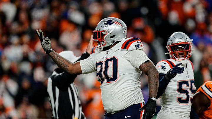 Dec 24, 2023; Denver, Colorado, USA; New England Patriots defensive tackle Christian Barmore (90) reacts after a play ]in the third quarter against the Denver Broncos at Empower Field at Mile High. Mandatory Credit: Isaiah J. Downing-Imagn Images
