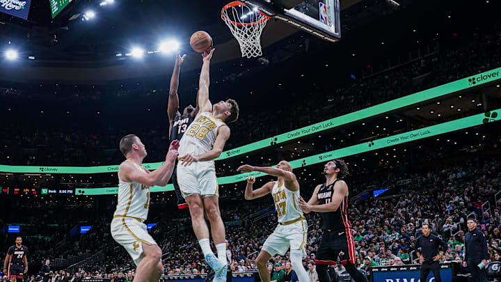 Dec 19, 2025; Boston, Massachusetts, USA; Boston Celtics guard Hugo Gonzalez (28) defends against Miami Heat center Bam Adebayo (13) in the first half at TD Garden. Mandatory Credit: David Butler II-Imagn Images