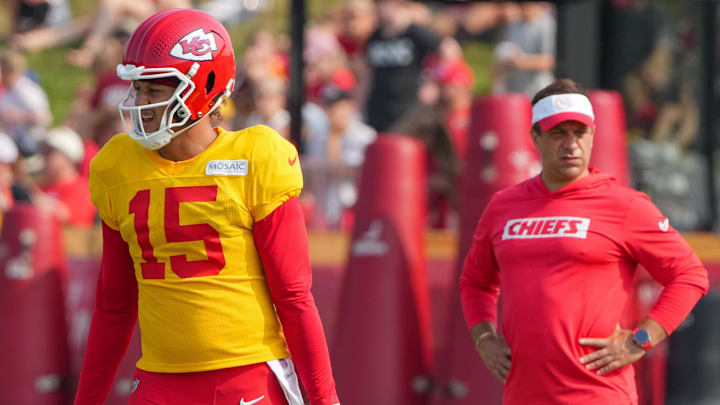 Jul 26, 2024; Kansas City, MO, USA; Kansas City Chiefs quarterback Patrick Mahomes (15) steps to the line as general manager Brett Veach watches in the background during training camp at Missouri Western State University. Mandatory Credit: Denny Medley-Imagn Images