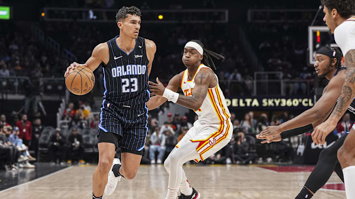Apr 13, 2025; Atlanta, Georgia, USA; Orlando Magic forward Tristan da Silva (23) dribbles against Atlanta Hawks guard Terance Mann (14) during the first half at State Farm Arena. Mandatory Credit: Dale Zanine-Imagn Images