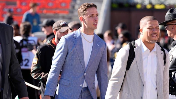 Georgia quarterback Carson Beck (15) arrives before the start of a NCAA college football game against Massachusetts in Athens, Ga., on Saturday, Nov. 23, 2024.