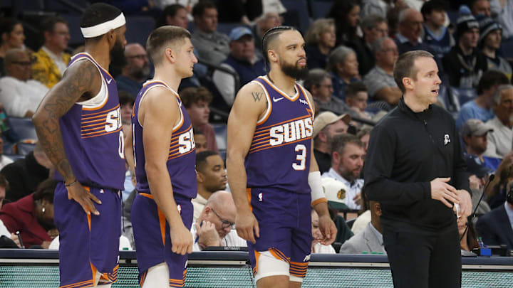 Jan 7, 2026; Memphis, Tennessee, USA; Phoenix Suns forward Royce O'Neale (00), guard Grayson Allen (8), forward Dillon Brooks (3) and head coach Jordan Ott look onduring the second quarter against the Memphis Grizzlies at FedExForum. Mandatory Credit: Petre Thomas-Imagn Images