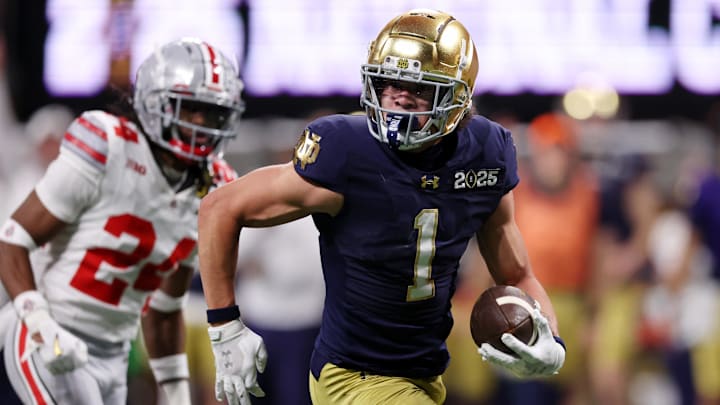 Jan 20, 2025; Atlanta, GA, USA; Notre Dame Fighting Irish wide receiver Jaden Greathouse (1) runs with the ball for a touchdown against the Ohio State Buckeyes during the second half the CFP National Championship college football game at Mercedes-Benz Stadium. 