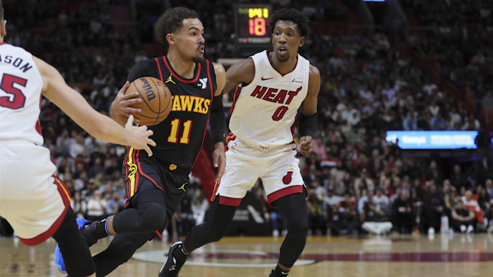Dec 22, 2023; Miami, Florida, USA; Atlanta Hawks guard Trae Young (11) drives to the basket past Miami Heat guard Josh Richardson (0) during the first quarter at Kaseya Center. Mandatory Credit: Sam Navarro-USA TODAY Sports