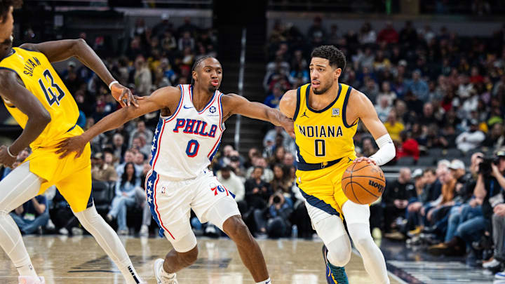 Jan 18, 2025; Indianapolis, Indiana, USA; Indiana Pacers guard Tyrese Haliburton (0) dribbles the ball while Philadelphia 76ers guard Tyrese Maxey (0) defends in the first half at Gainbridge Fieldhouse. Mandatory Credit: Trevor Ruszkowski-Imagn Images
