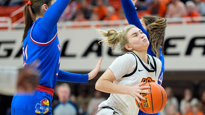 Oklahoma State Cowgirls guard Anna Gret Asi (4) goes to the basket during a women's BIG 12 basketball game between the Oklahoma State University Cowgirls (OSU) and the Kansas Jayhawks at Gallagher-Iba Arena in Stillwater, Okla., Saturday, Jan. 4, 2025.