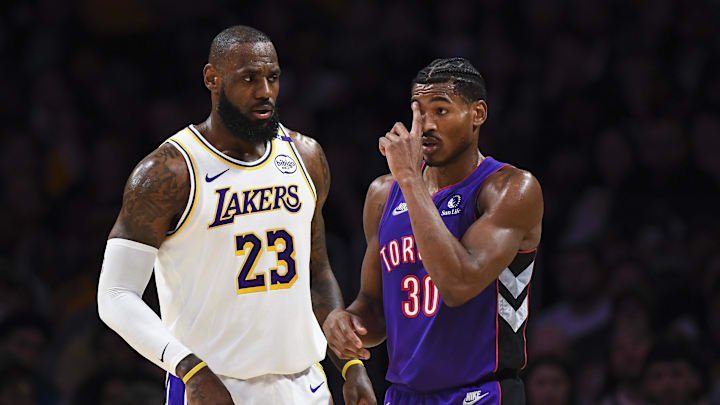 Nov 10, 2024; Los Angeles, California, USA; Los Angeles Lakers forward LeBron James (23) talks to Toronto Raptors guard Ochai Agbaji (30) during the first half at Crypto.com Arena. Mandatory Credit: Jonathan Hui-Imagn Images