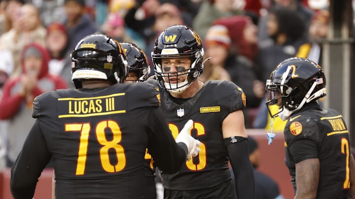 Dec 1, 2024; Landover, Maryland, USA; Washington Commanders tight end Zach Ertz (86) celebrates with Commanders offensive tackle Cornelius Lucas (78) after scoring a touchdown against the Tennessee Titans during the second half at Northwest Stadium. Mandatory Credit: Amber Searls-Imagn Images
