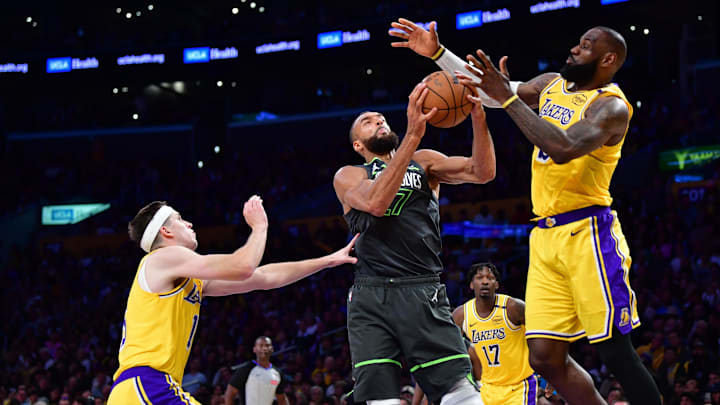 Apr 30, 2025; Los Angeles, California, USA; Minnesota Timberwolves center Rudy Gobert (27) gets the rebound against Los Angeles Lakers guard Austin Reaves (15) and forward LeBron James (23) during the second half in game five of first round for the 2025 NBA Playoffs at Crypto.com Arena. Mandatory Credit: Gary A. Vasquez-Imagn Images Apr 30, 2025; Los Angeles, California, USA; Minnesota Timberwolves center Rudy Gobert (27) gets the rebound against Los Angeles Lakers guard Austin Reaves (15) and forward LeBron James (23) during the second half in game five of first round for the 2025 NBA Playoffs at Crypto.com Arena. Mandatory Credit: Gary A. Vasquez-Imagn Images