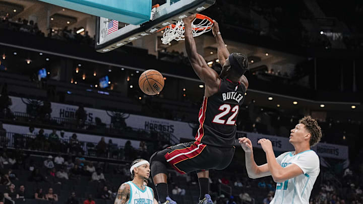 Oct 8, 2024; Charlotte, North Carolina, USA; Miami Heat forward Jimmy Butler (22) with a dunk against the Charlotte Hornets during the second quarter at Spectrum Center. Mandatory Credit: Jim Dedmon-Imagn Images