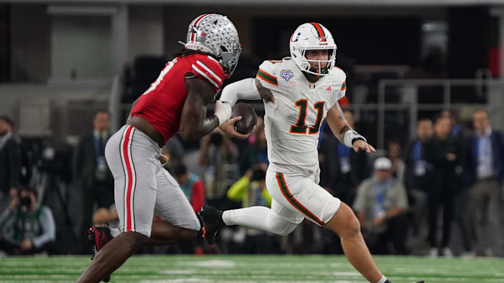 Dec 31, 2025; Arlington, TX, USA; Miami Hurricanes quarterback Carson Beck (11) carries the ball as Ohio State Buckeyes linebacker Arvell Reese (8) defends during second half the 2025 Cotton Bowl and quarterfinal game of the College Football Playoff at AT&T Stadium. Mandatory Credit: Raymond Carlin III-Imagn Images