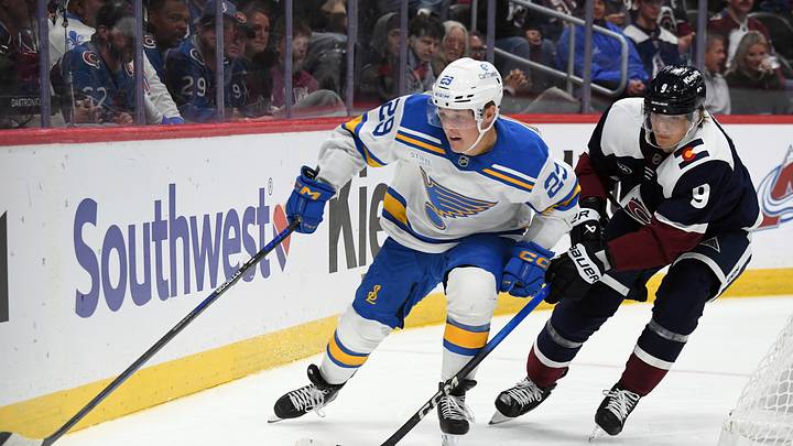 Oct 3, 2026; Denver, Colorado, USA; St. Louis Blues right winger Jonatan Berggren (29) handles the puck against Colorado Avalanche center Fedor Svechkov (9) in the third period at Ball Arena. Mandatory Credit: Christopher Hanewinckel-Imagn Images