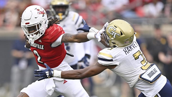 Sep 21, 2024; Louisville, Kentucky, USA;  Louisville Cardinals wide receiver Jadon Thompson (2) runs the ball against Georgia Tech Yellow Jackets defensive back Ahmari Harvey (3) during the second half at L&N Federal Credit Union Stadium. Louisville defeated Georgia Tech 31-19. Mandatory Credit: Jamie Rhodes-Imagn Images