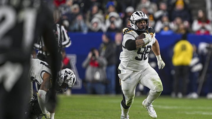 Dec 14, 2024; Landover, Maryland, USA;  Navy Midshipmen defensive tackle Landon Robinson (96) runs on na fake punt during the second half  against the Army Black Knights at Commanders Field. Mandatory Credit: Tommy Gilligan-Imagn Images