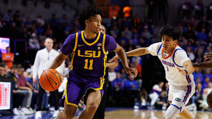 Jan 20, 2026; Gainesville, Florida, USA; Louisiana State Tigers guard Dedan Thomas Jr. (11) drives to the basket past Florida Gators guard Xaivian Lee (1) during the first half at Exactech Arena at the Stephen C. O'Connell Center. Mandatory Credit: Matt Pendleton-Imagn Images