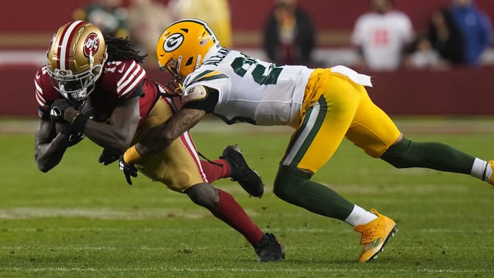 San Francisco 49ers wide receiver Brandon Aiyuk (11) makes an 11-yard reception before being tackled by Green Bay Packers cornerback Jaire Alexander (23) during the third quarter of their NFC divisional playoff game Saturday, January 20, 2024 at Levi    Stadium in Santa Clara, California. The San Francisco 49ers beat the Green Bay Packers 24-21.