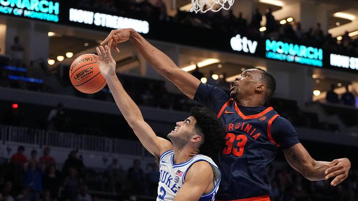 Mar 14, 2026; Charlotte, NC, USA; Virginia Cavaliers center Ugonna Onyenso (33) blocks the shot of Duke Blue Devils guard Cayden Boozer (2) in the second half during the men's ACC Conference Tournament Championship at Spectrum Center. Mandatory Credit: Bob Donnan-Imagn Images Mar 14, 2026; Charlotte, NC, USA; Virginia Cavaliers center Ugonna Onyenso (33) blocks the shot of Duke Blue Devils guard Cayden Boozer (2) in the second half during the men's ACC Conference Tournament Championship at Spectrum Center. Mandatory Credit: Bob Donnan-Imagn Images