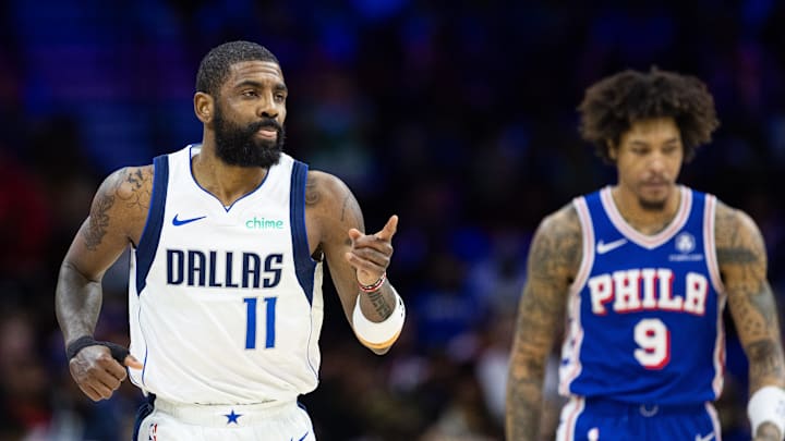 Feb 5, 2024; Philadelphia, Pennsylvania, USA; Dallas Mavericks guard Kyrie Irving (11) reacts in front of Philadelphia 76ers guard Kelly Oubre Jr. (9) after scoring during the third quarter at Wells Fargo Center. Mandatory Credit: Bill Streicher-Imagn Images