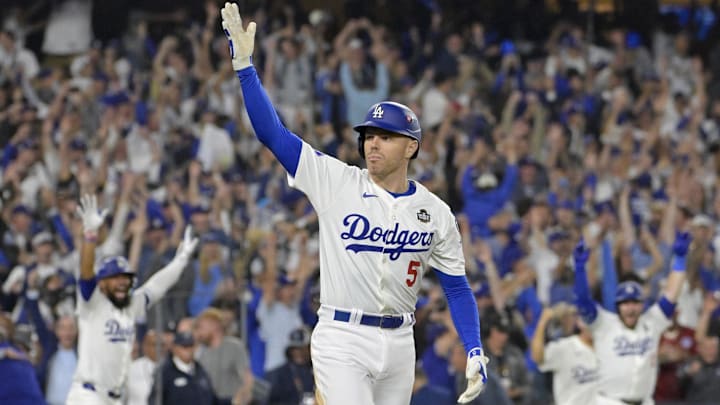 Oct 25, 2024; Los Angeles, California, USA; Los Angeles Dodgers first baseman Freddie Freeman (5) celebrates after hitting a grand slam home run in the tenth inning against the New York Yankees during game one of the 2024 MLB World Series at Dodger Stadium. Mandatory Credit: Jayne Kamin-Oncea-Imagn Images