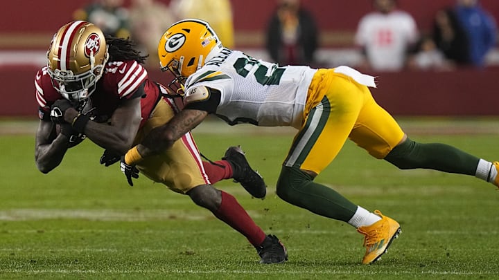 Green Bay Packers cornerback Jaire Alexander tackles 49ers receiver Brandon Aiyuk. Neither will play on Sunday.