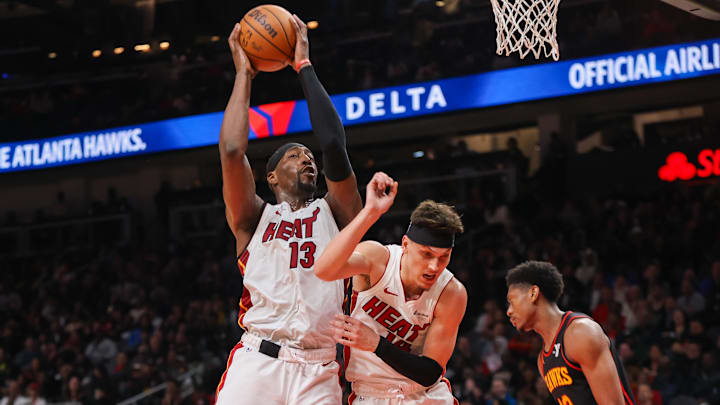 Apr 9, 2024; Atlanta, Georgia, USA; Miami Heat center Bam Adebayo (13) grabs a rebound past guard Apr 9, 2024; Atlanta, Georgia, USA; Miami Heat center Bam Adebayo (13) grabs a rebound past guard