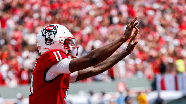 Sep 6, 2025; Raleigh, North Carolina, USA; North Carolina State Wolfpack quarterback CJ Bailey (11) celebrates a touchdown during the second half of the game against Virginia Cavaliers at Carter-Finley Stadium. Mandatory Credit: Jaylynn Nash-Imagn Images Sep 6, 2025; Raleigh, North Carolina, USA; North Carolina State Wolfpack quarterback CJ Bailey (11) celebrates a touchdown during the second half of the game against Virginia Cavaliers at Carter-Finley Stadium. Mandatory Credit: Jaylynn Nash-Imagn Images