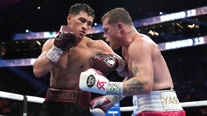 May 7, 2022; Las Vegas, Nevada, USA; Canelo Alvarez (pink trunks) and Dimitry Bivol (black trunks) box during their light heavyweight championship bout at T-Mobile Arena. Mandatory Credit: Joe Camporeale-Imagn Images
