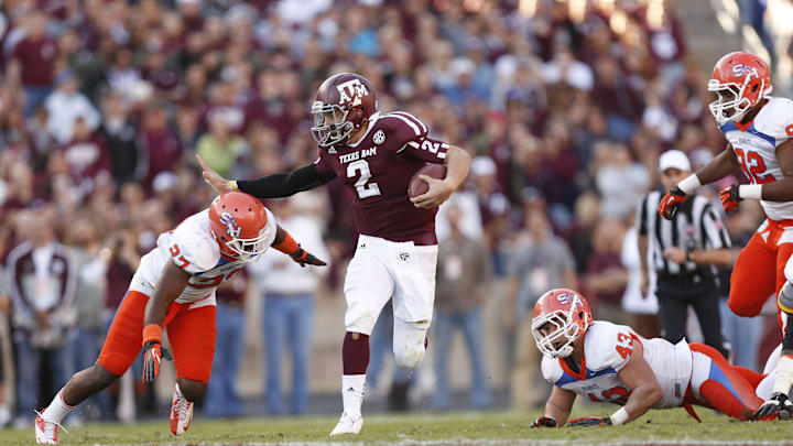 Nov 17, 2012; College Station, TX, USA;  Texas A&M Aggies quarterback Johnny Manziel (2) stiff arms Sam Houston State Bearkats defensive back Mike Littleton (27) during the first half at Kyle Field. Mandatory Credit: Thomas Campbell-Imagn Images