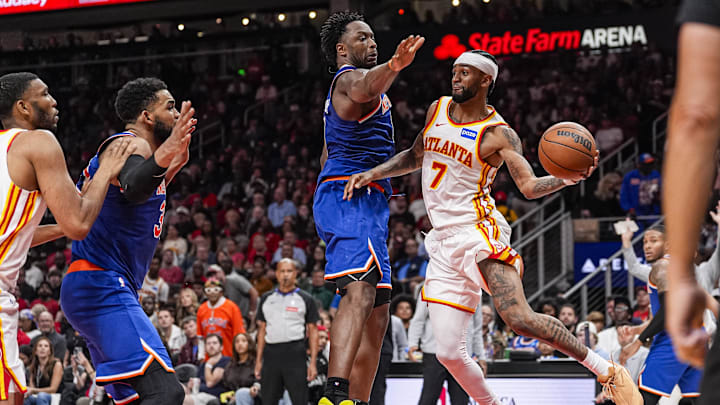 Apr 25, 2026; Atlanta, Georgia, USA; Atlanta Hawks guard Nickeil Alexander-Walker (7) passes the ball past New York Knicks forward Og Anunoby (8) during the second half during game four of the first round of the 2026 NBA Playoffs at State Farm Arena. Mandatory Credit: Dale Zanine-Imagn Images