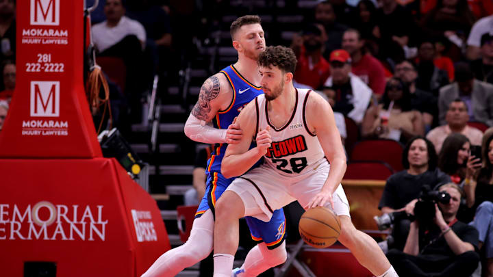 Apr 4, 2025; Houston, Texas, USA; Houston Rockets center Alperen Sengun (28) handles the ball inside against Oklahoma City Thunder center Isaiah Hartenstein (55) during the third quarter at Toyota Center. Mandatory Credit: Erik Williams-Imagn Images